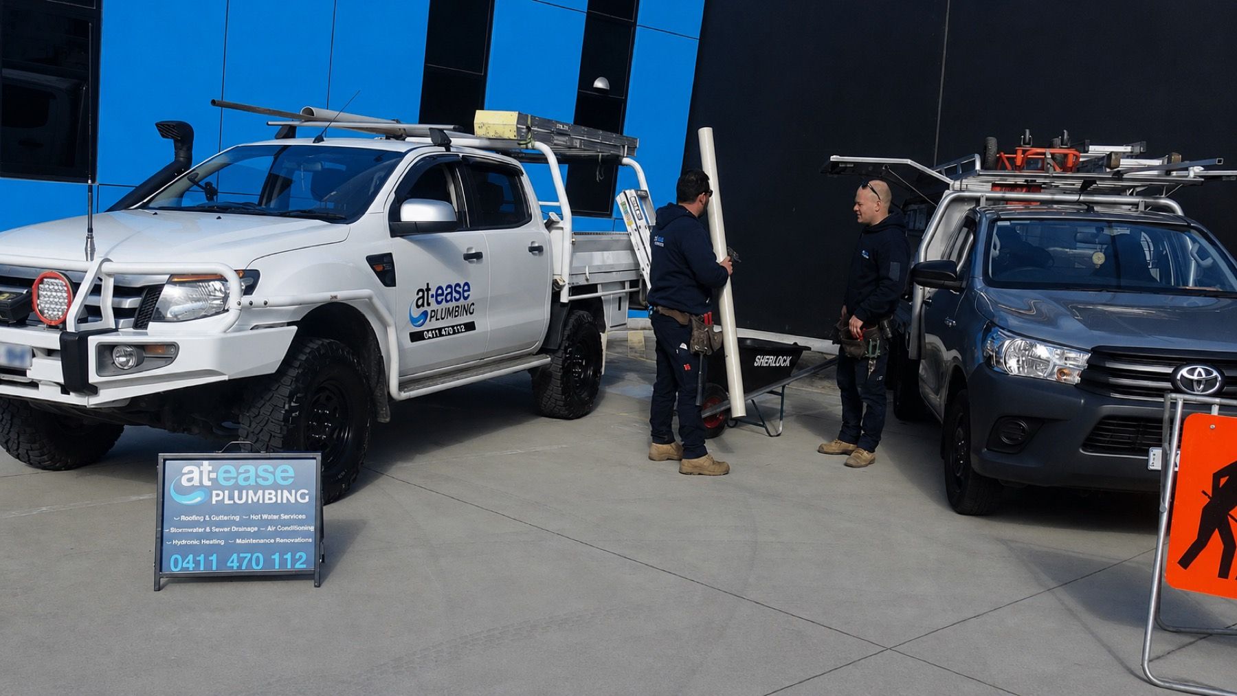 At-Ease Plumbing service vehicles on site